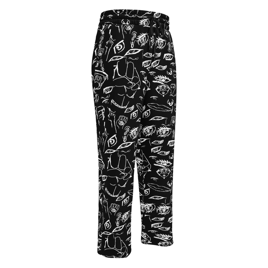 Doodle wide-leg joggers in White on Black, flat front view: all-over hand-drawn doodles of eyes, hands and faces in white ink on black