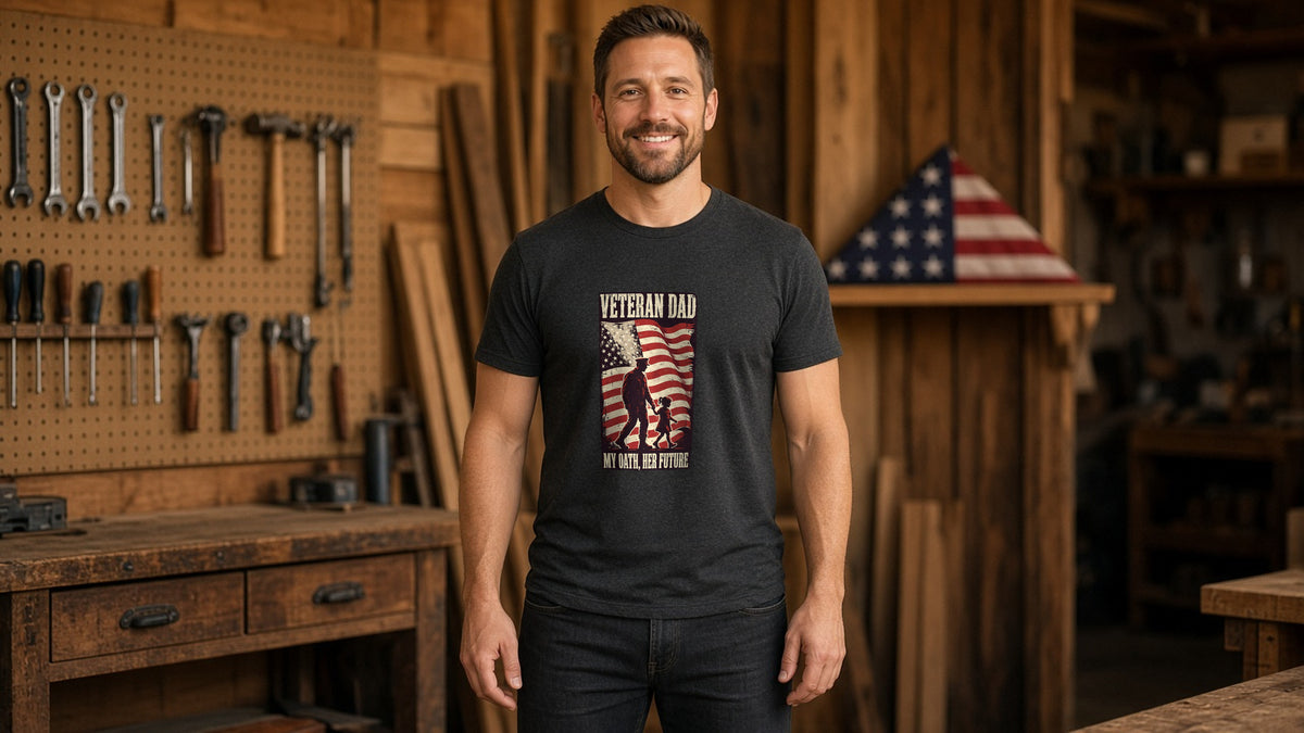 Man in a black Dad. Veteran. Hero. Grill Master. tee in a wood-paneled workshop with an American flag on the wall
