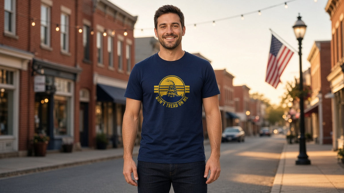Man in a navy Don't Tread On Me Retro Sunset T-Shirt on a small-town main street lined with American flags