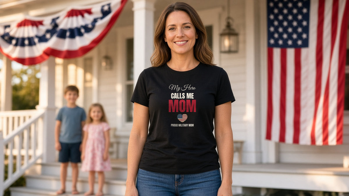 Mom in a black My Hero Calls Me Mom military mom tee on a flag-draped front porch with her two children