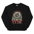 Black crewneck sweatshirt with a woodcut crown sinking into the sea inside a red sunburst, printed with It's Not Us. It's You. Signed, The Thirteen.